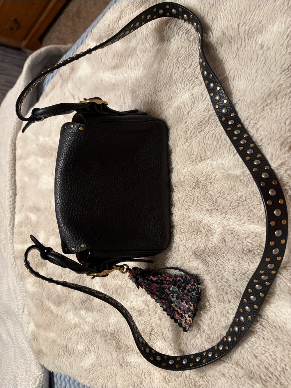 Black Leather Crossbody Bag with Studded Strap and Tassel Accent